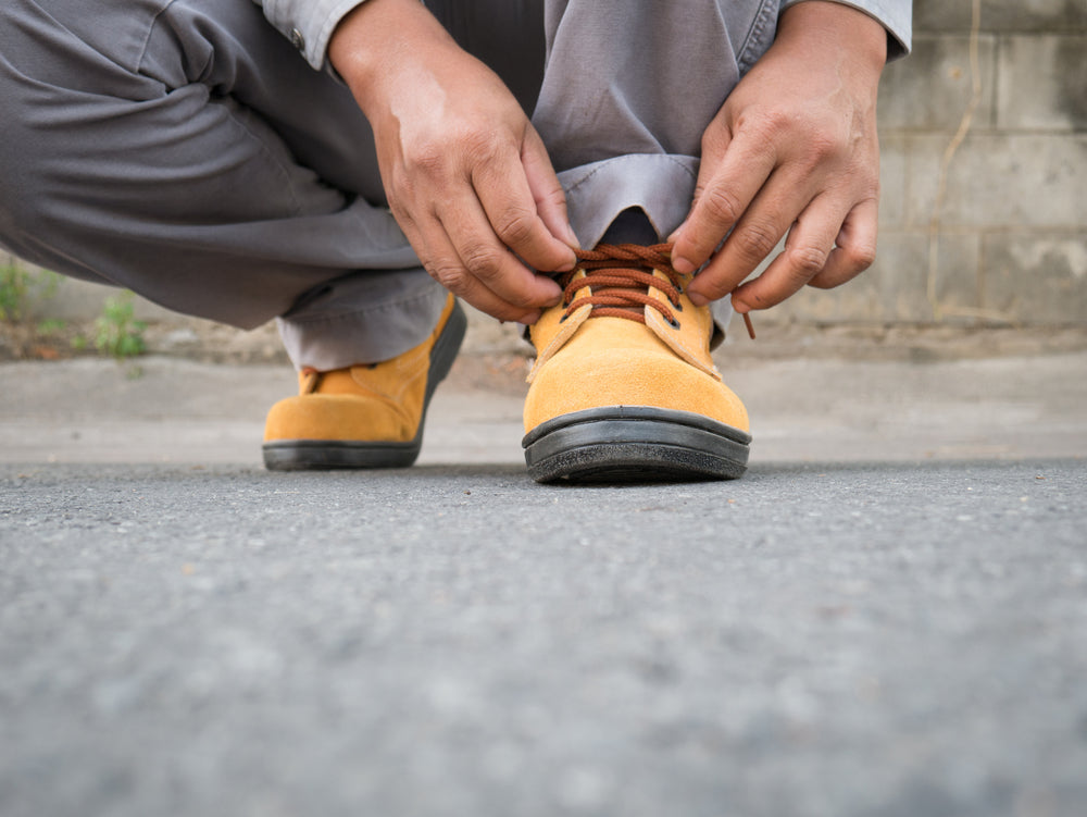 tying laces of work boots